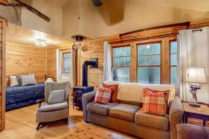 a living room with a couch and a chair at Little Red Lakeside Cabin in Three Lakes +27 photos
