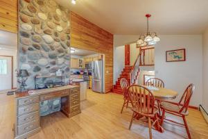 a kitchen and dining room with a table and a stone wall at Tall Pines in Woodruff