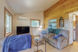 a living room with a couch and a tv at Tall Pines in Woodruff