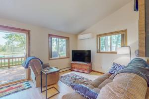 a living room with a couch and a flat screen tv at Tall Pines in Woodruff +19 photos