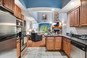 a large kitchen with wooden cabinets and a living room at Chula Vista Condo 2145 & 2147 Full Property in Wisconsin Dells
