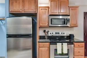 a kitchen with a stove and a microwave at Chula Vista Condo 2145 & 2147 Full Property in Wisconsin Dells +29 photos