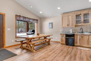 a kitchen with a wooden table and a wooden floor at The Fish in Conover +41 photos