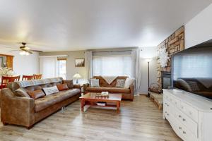 a living room with two couches and a tv at Knotty Pines in Wisconsin Dells