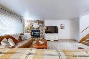 a living room with a couch and a fireplace at Knotty Pines in Wisconsin Dells
