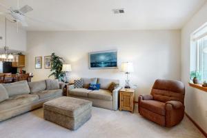 a living room with a couch and a chair at Lighthouse Cove Condo Resort: 418 in Wisconsin Dells