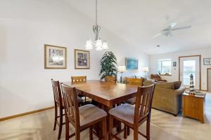 a living room with a wooden table and chairs at Lighthouse Cove Condo Resort: 418 in Wisconsin Dells