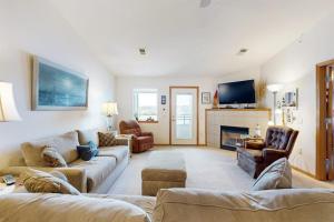 a living room with two couches and a fireplace at Lighthouse Cove Condo Resort: 418 in Wisconsin Dells