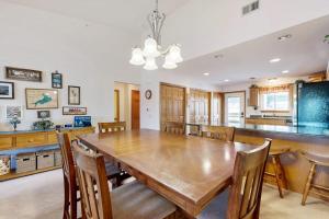 a kitchen and dining room with a wooden table and chairs at Lighthouse Cove Condo Resort: 418 in Wisconsin Dells +47 photos