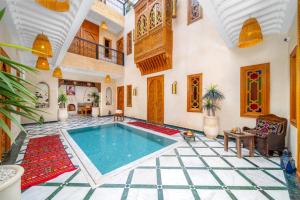a villa with a swimming pool in a room at Riad Nadalinn in Marrakesh