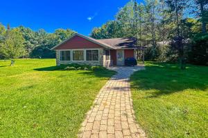 a small house with a brick path in front of it at Watermelon Retreat & Suite in Three Lakes +36 photos