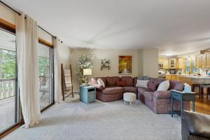 a living room with a couch and a table at Hooked on Johnson in Arbor Vitae