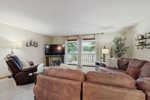 a living room with a couch and a television at Hooked on Johnson in Arbor Vitae