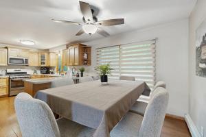 a dining room with a table and a ceiling fan at Hooked on Johnson in Arbor Vitae +22 photos