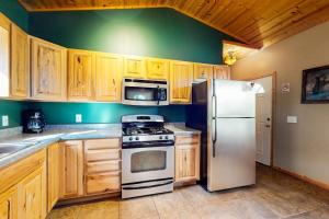a kitchen with a white refrigerator and wooden cabinets at The Honeymoon in Mercer