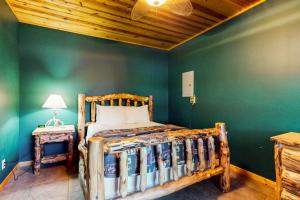a bedroom with a wooden bed and a green wall at The Honeymoon in Mercer +17 photos