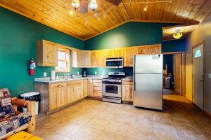 a kitchen with wooden cabinets and a stainless steel refrigerator at The Honeymoon in Mercer