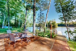 a patio with a table and chairs next to a lake at The Aspen in Mercer