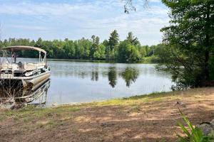 a boat sitting on the shore of a lake at The Hunters Den in Mercer