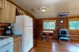 a kitchen with a white refrigerator and a stove at The Hunters Den in Mercer +26 photos