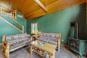 a living room with two couches and a wood stove at Pine Tree House in Mercer