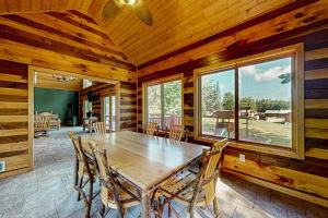 a dining room with a wooden table and chairs at Pine Tree House in Mercer +25 photos