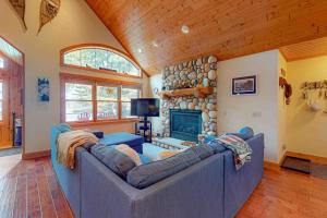 a living room with a couch and a fireplace at Shangri La in Eagle River