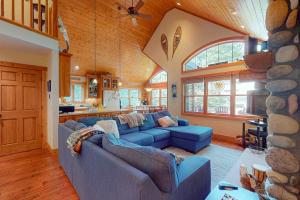a living room with blue couches and a stone wall at Shangri La in Eagle River