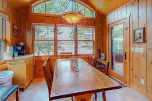 a dining room with a wooden table and chairs at Shangri La in Eagle River