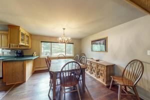 a kitchen with a dining room table and chairs at Wild Bear Retreat in Saint Germain