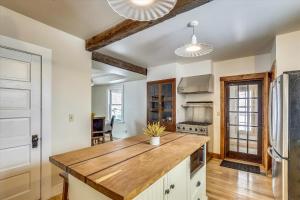 a kitchen with a wooden counter top in a room at Cozy Villager in Stowe