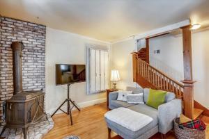 a living room with a couch and a fireplace at Cozy Villager in Stowe +15 photos