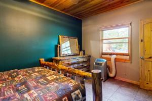 a bedroom with a bed and a mirror and a window at Gateway Lodge in Mercer +42 photos