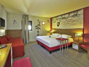 ein Hotelzimmer mit einem Bett und einer Couch in der Unterkunft ibis Styles Castres in Castres + 69 Fotos