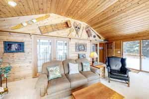 a living room with a couch and a chair at Bayside Secret in Phelps