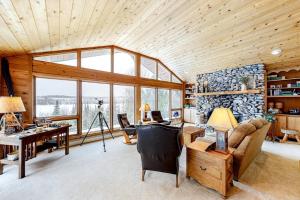 a living room with a desk and a couch at Bayside Secret in Phelps