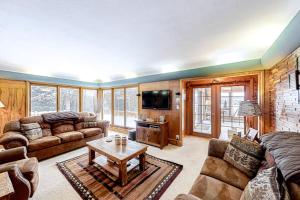 a living room with a couch and a tv at Bayside Secret in Phelps