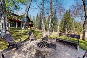 a patio with chairs and a fire pit and a house at Blissful St Germain Retreat in Saint Germain