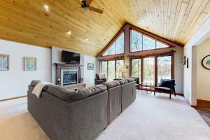 a living room with couches and a ceiling at Blissful St Germain Retreat in Saint Germain