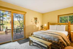 a bedroom with a bed and a sliding glass door at Northwoods Paradise in Eagle River +22 photos