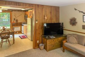 a living room with a flat screen tv on a wooden entertainment center at Cleerwood Village #261 in Eagle River