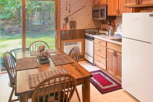 a kitchen with a wooden table and a white refrigerator at Cleerwood Village #261 in Eagle River