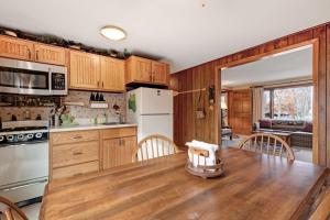 a kitchen with wooden cabinets and a wooden table at Cleerwood Village #261 in Eagle River