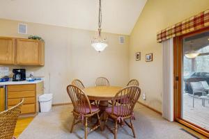 a dining room with a table and chairs and a kitchen at Nekoosa Holiday in New Rome
