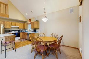 a kitchen with a wooden table and chairs in a room at Nekoosa Holiday in New Rome