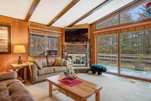 a living room with a couch and a fireplace at Catfish Lake Home in Eagle River