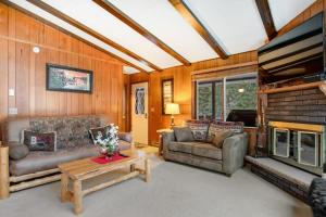 a living room with two couches and a fireplace at Catfish Lake Home in Eagle River