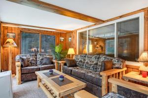 a living room with a couch and a table at Catfish Lake Home in Eagle River