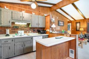 a kitchen with wooden cabinets and a ceiling fan at Catfish Lake Home in Eagle River +27 photos
