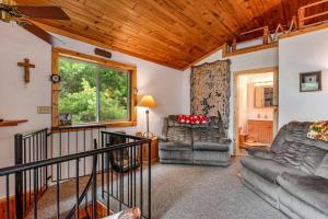 a living room with two couches and a cross on the wall at One Acre Wood in Eagle River